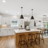 Pheasant Run Sadie Cottage Rambler Detached Villa – Kitchen with custom cabinets, wood hood and 36 gas cooktop